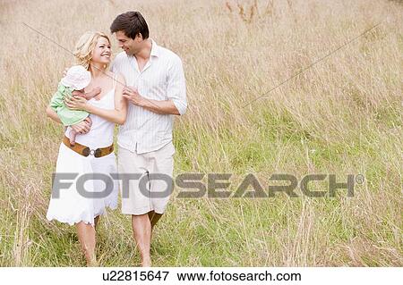 Family walking outdoors smiling View Large Photo Image Stock Photo - Family walking outdoors smiling. Fotosearch