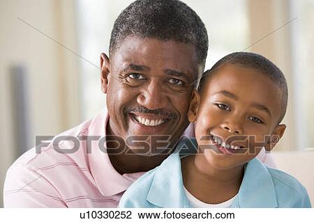 Grandfather and grandson indoors smiling View Large Photo Image Stock Image - Grandfather and grandson indoors smiling. Fotosearch