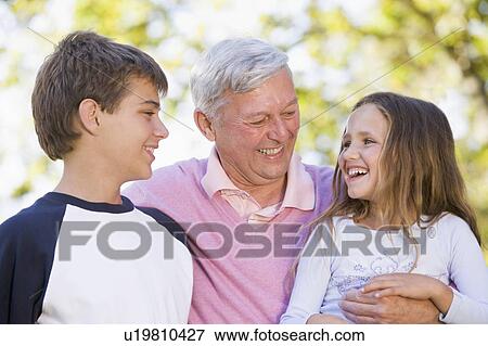 Grandfather laughing with grandchildren. View Large Photo Image Stock Photo - Grandfather laughing with grandchildren.. Fotosearch