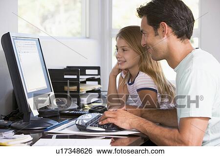 Stock Photograph - Man and young girl in home office with computer smiling. Fotosearch