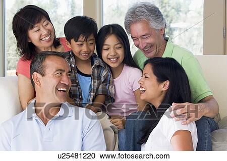 Extended family in living room smiling View Large Photo Image Stock Image - Extended family in living room smiling. Fotosearch