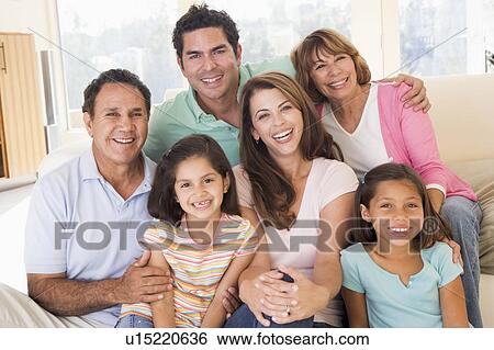 Extended family in living room smiling View Large Photo Image Stock Photograph - Extended family in living room smiling. Fotosearch