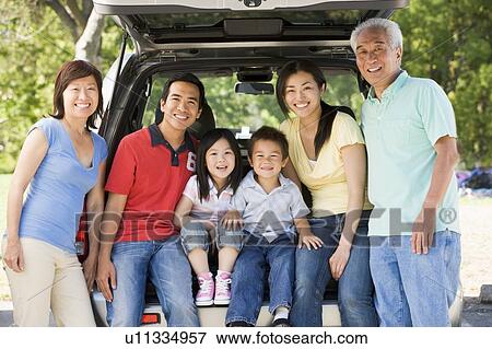 Extended family sitting in tailgate of car View Large Photo Image Stock Photo - Extended family sitting in tailgate of car. Fotosearch