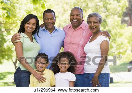 Extended family standing in park smiling View Large Photo Image Picture - Extended family standing in park smiling. Fotosearch