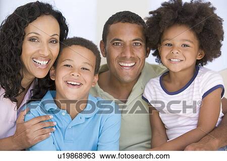 Family in living room smiling View Large Photo Image Stock Image - Family in living room smiling. Fotosearch