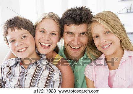 Family in living room smiling View Large Photo Image Stock Photo - Family in living room smiling. Fotosearch