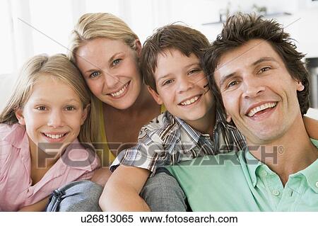 Family in living room smiling View Large Photo Image Stock Photography - Family in living room smiling. Fotosearch