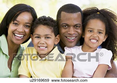 Family outdoors smiling View Large Photo Image Stock Photo - Family outdoors smiling. Fotosearch