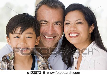 Stock Photograph - Family together smiling. Fotosearch