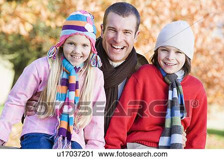 Father and two young children outdoors in park smiling (selective focus) View Large Photo Image Stock Image - Father and two young children outdoors in park smiling (selective focus). Fotosearch