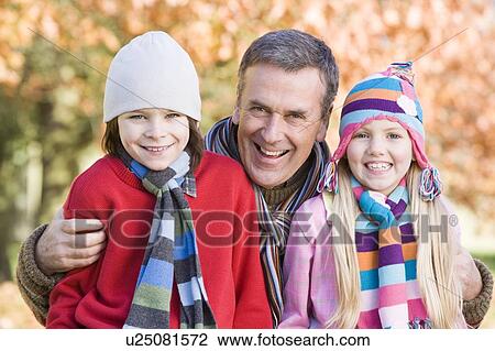 Grandfather and two children outdoors in park smiling (selective focus) View Large Photo Image Stock Image - Grandfather and two children outdoors in park smiling (selective focus). Fotosearch
