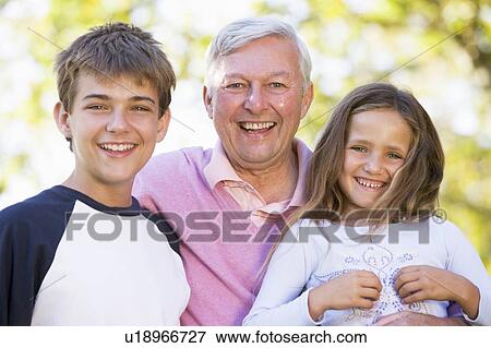 Grandfather laughing with grandchildren. View Large Photo Image Stock Photo - Grandfather laughing with grandchildren.. Fotosearch