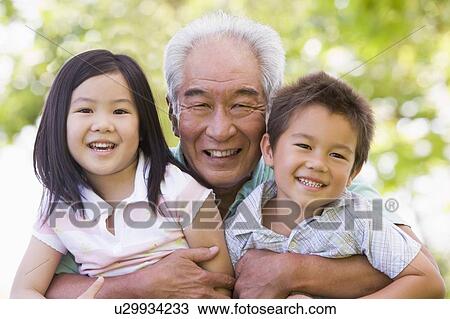 Grandfather posing with grandchildren. View Large Photo Image Stock Image - Grandfather posing with grandchildren.. Fotosearch