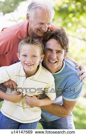 Grandfather with adult son and grandchild in park View Large Photo Image Stock Photo - Grandfather with adult son and grandchild in park. Fotosearch