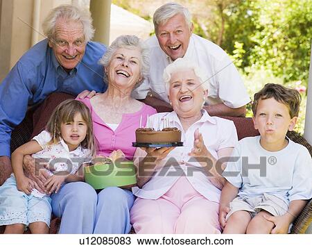 Grandparents and grandchildren on patio with cake and gift smiling View Large Photo Image Stock Image - Grandparents and grandchildren on patio with cake and gift smiling. Fotosearch