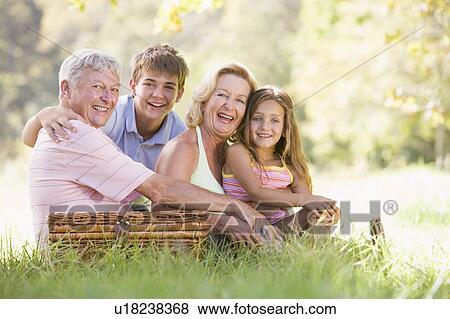 Stock Photo - Grandparents having a picnic with grandchildren.. Fotosearch
