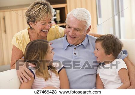 Stock Photo - Grandparents laughing with grandchildren.. Fotosearch