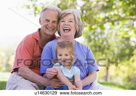 Grandparents with granddaughter in park View Large Photo Image Stock Photo - Grandparents with granddaughter in park. Fotosearch