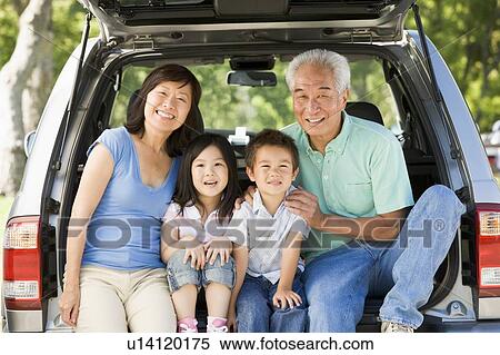 Stock Photography - Grandparents with grandkids in tailgate of car. Fotosearch