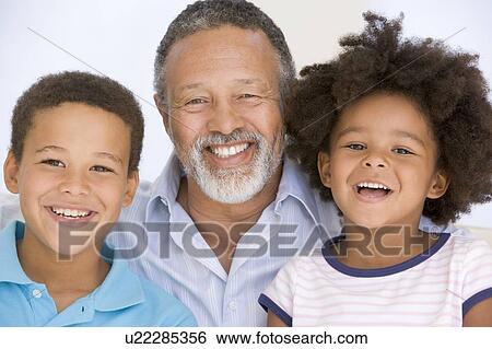 Man and two young children smiling View Large Photo Image Stock Photograph - Man and two young children smiling. Fotosearch