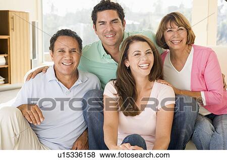 Two couples sitting in living room smiling View Large Photo Image Stock Photo - Two couples sitting in living room smiling. Fotosearch