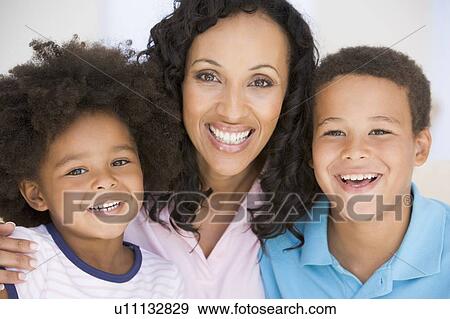 Woman and two young children smiling View Large Photo Image Stock Photo - Woman and two young children smiling. Fotosearch