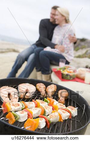 Picture - Couple Cooking On A Barbeque. Fotosearch