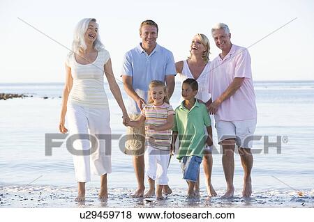 Stock Photo - Extended family at the beach smiling. Fotosearch