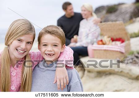 Stock Photography - Family at beach with picnic smiling. Fotosearch