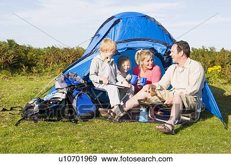 Family camping with tent and cooking View Large Photo Image Stock Photo - Family camping with tent and cooking. Fotosearch