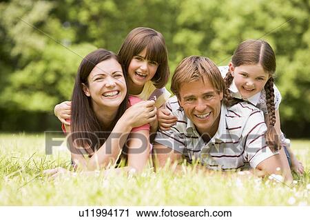 Stock Image - Family outdoors smiling. Fotosearch