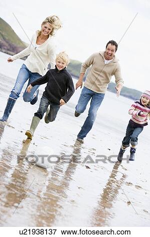 Family playing soccer at beach smiling View Large Photo Image Stock Photo - Family playing soccer at beach smiling. Fotosearch