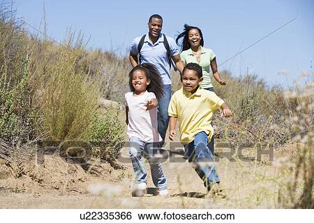 Family running on path smiling View Large Photo Image Stock Photograph - Family running on path smiling. Fotosearch