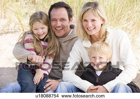 Family sitting on beach smiling View Large Photo Image Picture - Family sitting on beach smiling. Fotosearch