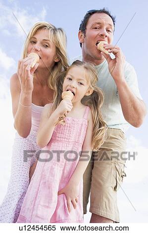 Family standing outdoors with ice cream View Large Photo Image Stock Photography - Family standing outdoors with ice cream. Fotosearch