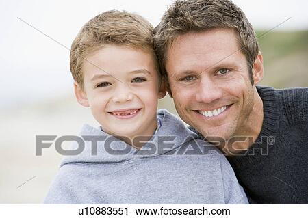 Father and son at beach smiling View Large Photo Image Stock Image - Father and son at beach smiling. Fotosearch