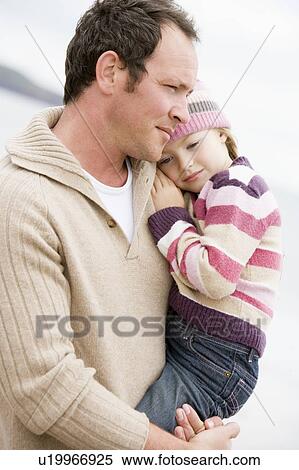 Father holding daughter at beach View Large Photo Image Stock Photography - Father holding daughter at beach. Fotosearch