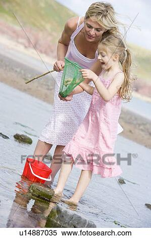 Mother and daughter at beach fishing and smiling View Large Photo Image Stock Photography - Mother and daughter at beach fishing and smiling. Fotosearch