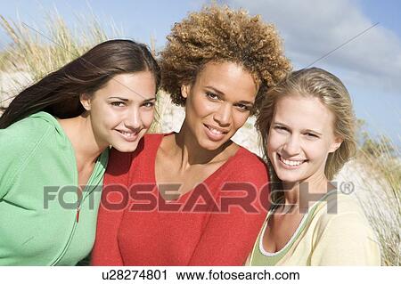 Three women posing outdoors View Large Photo Image Stock Image - Three women posing outdoors. Fotosearch