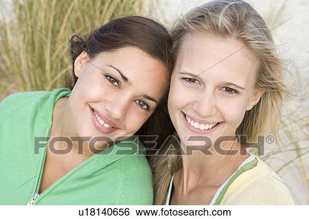 Stock Photograph - Two young women posing outdoors. Fotosearch