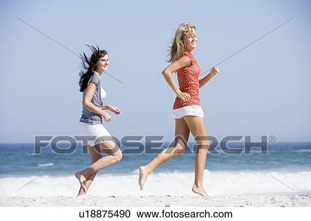 Women jogging on a beach View Large Photo Image Stock Image - Women jogging on a beach. Fotosearch
