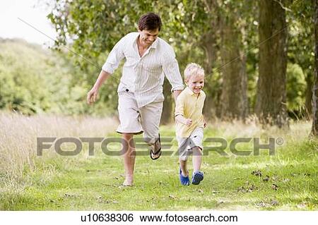 Father and son running on path smiling View Large Photo Image Stock Photograph - Father and son running on path smiling. Fotosearch