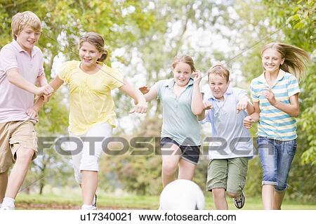 Five young friends playing soccer View Large Photo Image Stock Image - Five young friends playing soccer. Fotosearch