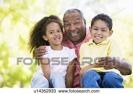 Grandfather laughing with grandchildren. View Large Photo Image Stock Image - Grandfather laughing with grandchildren.. Fotosearch