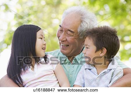 Grandfather laughing with grandchildren. View Large Photo Image Stock Photo - Grandfather laughing with grandchildren.. Fotosearch