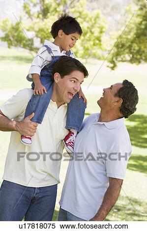 Stock Photography - Grandfather with adult son and grandchild. Fotosearch