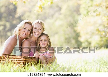 Picture - Grandmother with adult daughter and grandchild on picnic. Fotosearch