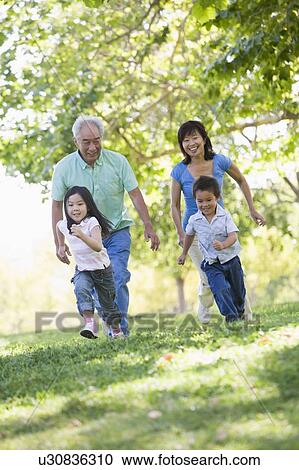 Grandparents running with grandchildren. View Large Photo Image Stock Image - Grandparents running with grandchildren.. Fotosearch