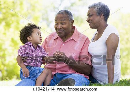 Grandparents with grandson in park View Large Photo Image Picture - Grandparents with grandson in park. Fotosearch