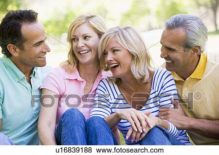 Stock Photo - Two couples outdoors smiling. Fotosearch